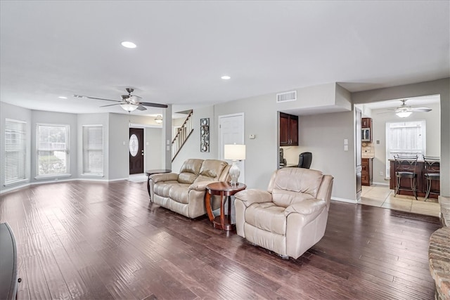 living room with hardwood / wood-style floors and ceiling fan