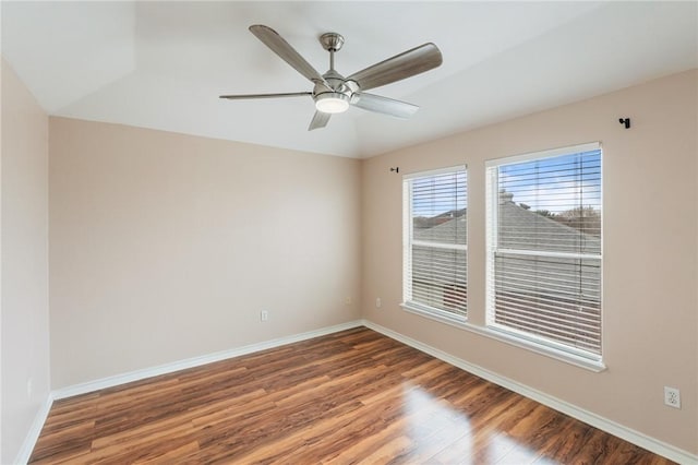 empty room featuring dark hardwood / wood-style flooring and ceiling fan