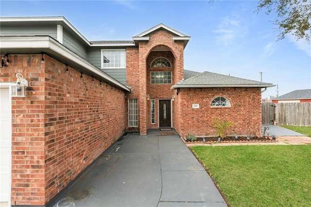 entrance to property with a lawn