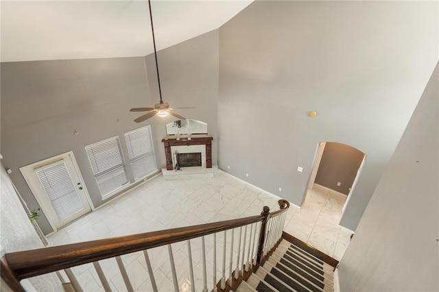 stairs with high vaulted ceiling and ceiling fan