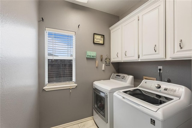 laundry room with cabinets and washer and dryer