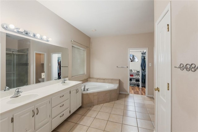 full bathroom featuring tile patterned flooring, vanity, plus walk in shower, and toilet