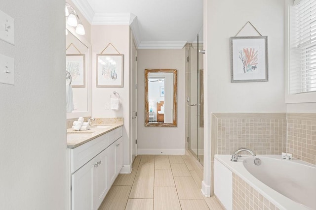 bathroom with crown molding, vanity, a shower stall, and a garden tub
