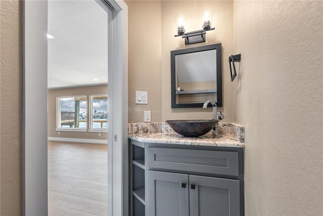 15334 Key Largo Ct, Corpus Christi, TX 78418 - bathroom featuring a textured wall, wood finished floors, vanity, and recessed lighting