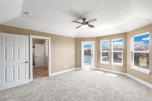 15334 Key Largo Ct, Corpus Christi, TX 78418 - unfurnished bedroom with carpet, baseboards, vaulted ceiling, a ceiling fan, and a raised ceiling