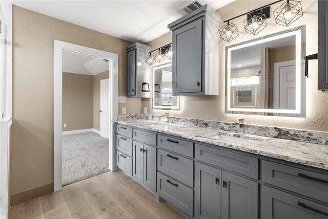 15334 Key Largo Ct, Corpus Christi, TX 78418 - full bathroom featuring wood finished floors, double vanity, and baseboards