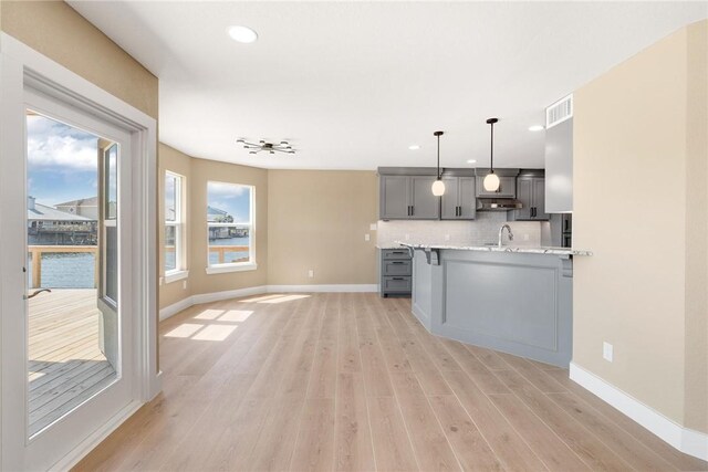 15334 Key Largo Ct, Corpus Christi, TX 78418 - kitchen featuring gray cabinets, baseboards, light wood finished floors, recessed lighting, and tasteful backsplash