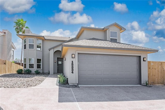 15334 Key Largo Ct, Corpus Christi, TX 78418 - view of front of property with fence, stucco siding, driveway, a garage, and roof with shingles