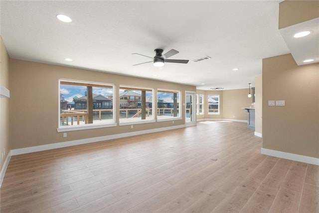 15334 Key Largo Ct, Corpus Christi, TX 78418 - unfurnished living room with a ceiling fan, baseboards, recessed lighting, and light wood-style floors