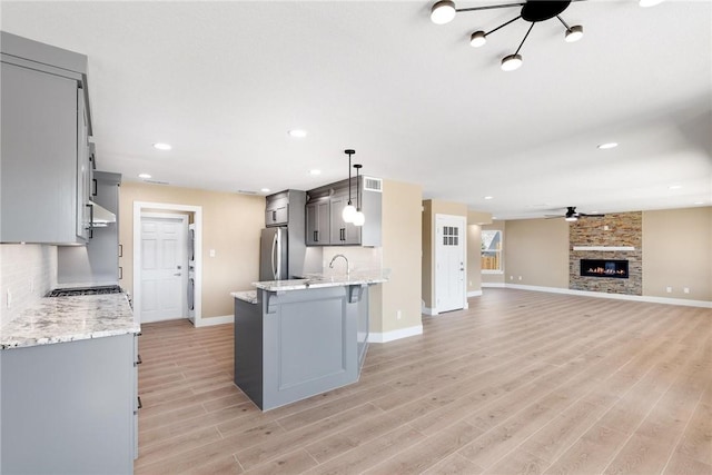 15334 Key Largo Ct, Corpus Christi, TX 78418 - kitchen featuring freestanding refrigerator, gray cabinetry, a ceiling fan, baseboards, and light wood-style floors