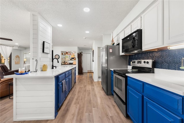 kitchen with white cabinetry, blue cabinets, a textured ceiling, appliances with stainless steel finishes, and light wood-type flooring