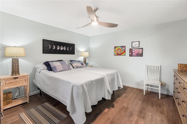 bedroom featuring hardwood / wood-style flooring, ceiling fan, and a textured ceiling