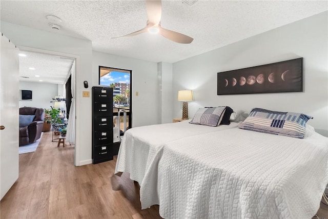 1400 Ocean Dr Unit 304C, Corpus Christi, TX 78404 - bedroom featuring a textured ceiling, light wood-style floors, ceiling fan, and access to outside