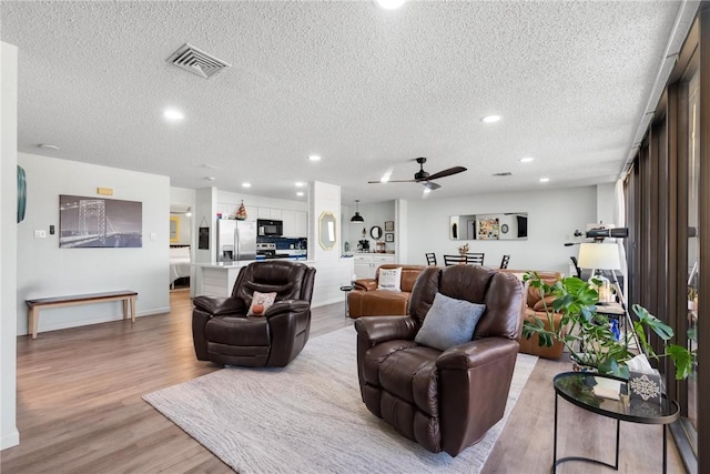 1400 Ocean Dr Unit 304C, Corpus Christi, TX 78404 - living room featuring a textured ceiling, light wood finished floors, recessed lighting, and ceiling fan