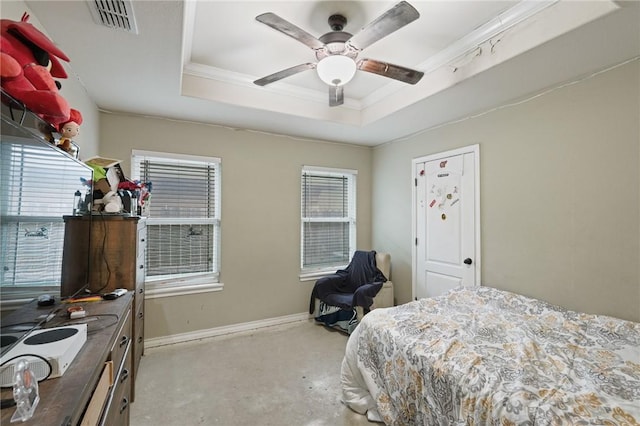 bedroom with visible vents, baseboards, ceiling fan, ornamental molding, and a tray ceiling