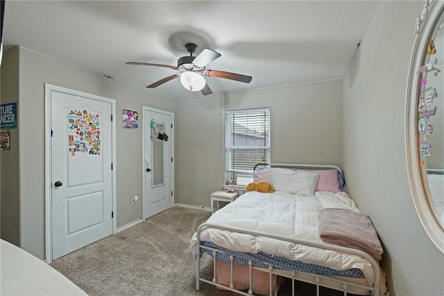 carpeted bedroom featuring a ceiling fan and baseboards