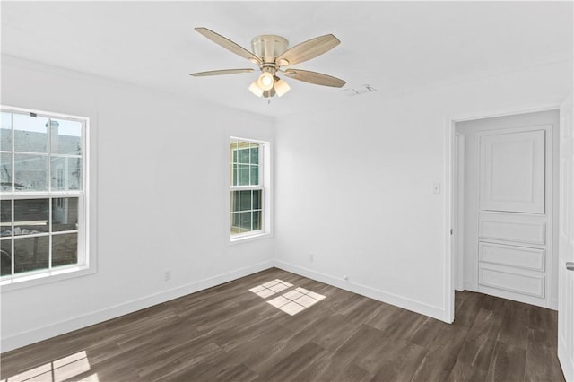 1113 Annapolis Dr, Corpus Christi, TX 78404 - empty room featuring dark wood-type flooring, baseboards, and a ceiling fan