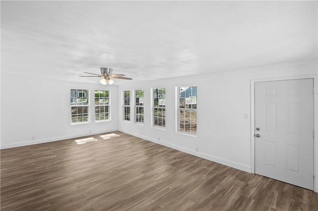 1113 Annapolis Dr, Corpus Christi, TX 78404 - unfurnished living room featuring ceiling fan, plenty of natural light, wood finished floors, and crown molding