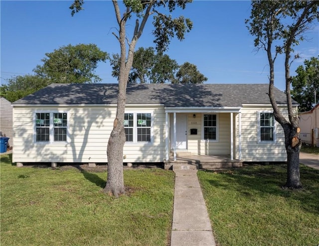 1113 Annapolis Dr, Corpus Christi, TX 78404 - view of front of home featuring a porch, a front lawn, and roof with shingles
