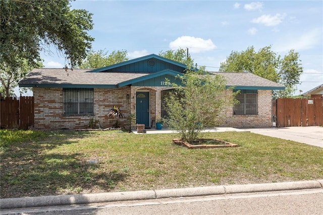 1124 Orange St, Mercedes, TX 78570 - ranch-style home featuring brick siding and board and batten siding