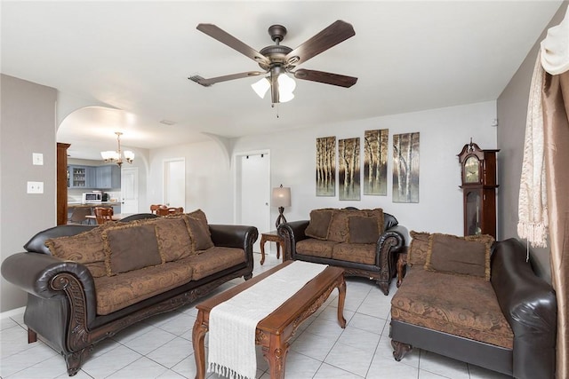 1124 Orange St, Mercedes, TX 78570 - living area with a chandelier, ceiling fan, arched walkways, and light tile patterned flooring