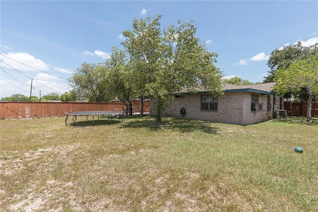 1124 Orange St, Mercedes, TX 78570 - view of yard with a trampoline and central air condition unit