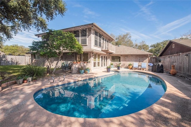 view of pool with a patio area, a fenced backyard, and a fenced in pool