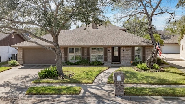 view of front of house featuring a garage, brick siding, driveway, roof with shingles, and a front yard