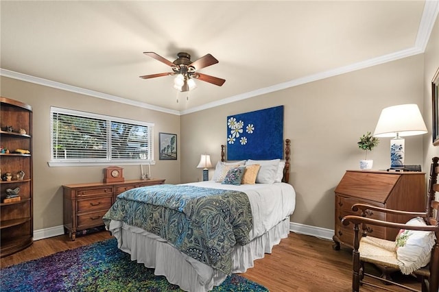 bedroom featuring baseboards, wood finished floors, a ceiling fan, and crown molding