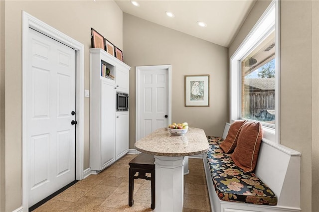 dining room with vaulted ceiling and recessed lighting