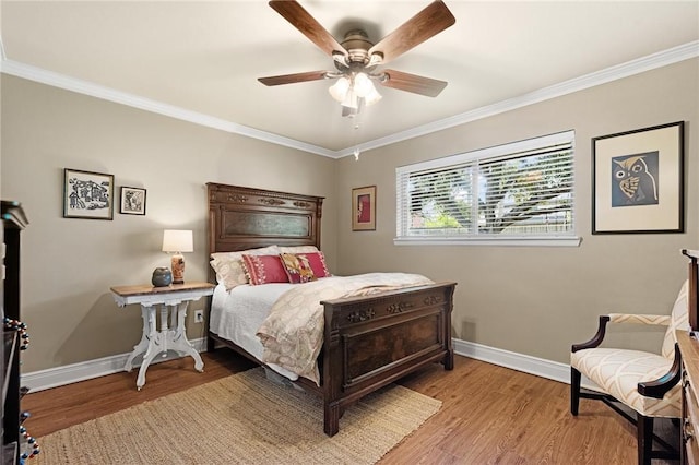 bedroom with ceiling fan, ornamental molding, wood finished floors, and baseboards