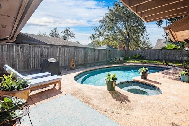 view of swimming pool featuring a patio, a fenced backyard, a fenced in pool, and an in ground hot tub