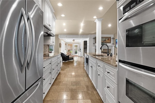 kitchen featuring appliances with stainless steel finishes, recessed lighting, a sink, and white cabinets