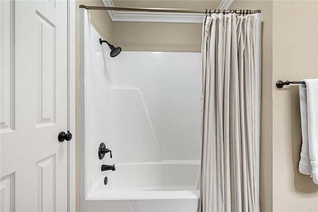 bathroom with shower / tub combo and crown molding