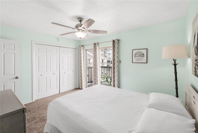 carpeted bedroom featuring a textured ceiling, a closet, a ceiling fan, and access to exterior