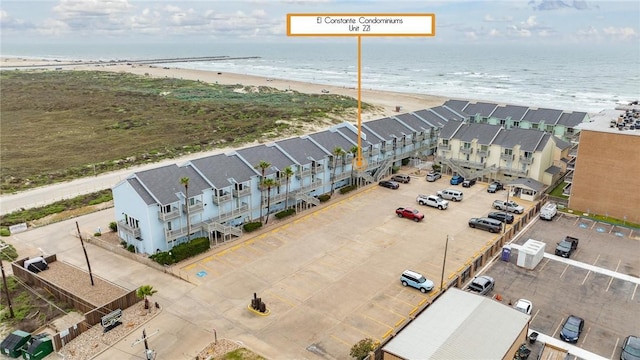 birds eye view of property featuring a beach view and a water view