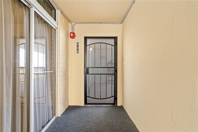 entrance to property with stucco siding