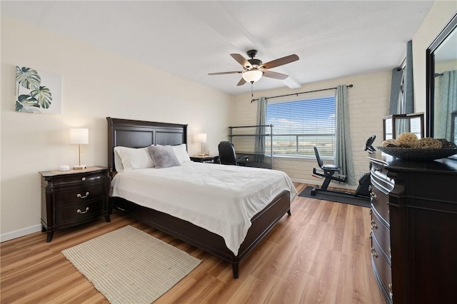 bedroom with light wood-style flooring, baseboards, and ceiling fan