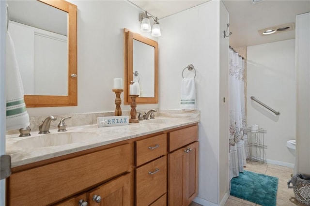 full bath featuring tile patterned floors, double vanity, baseboards, and a sink