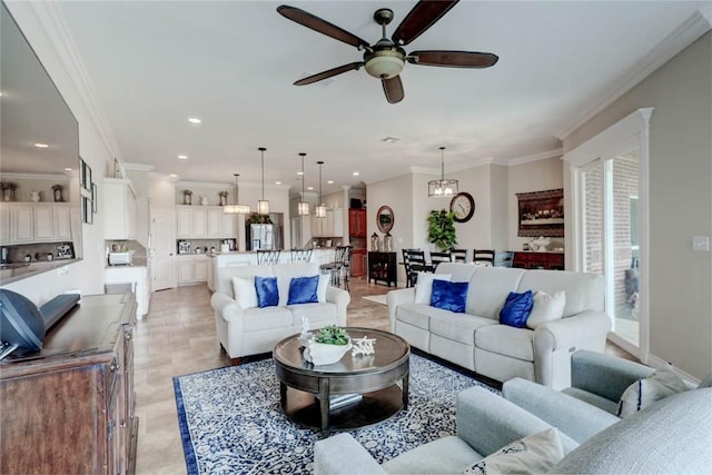 living room with ceiling fan with notable chandelier and ornamental molding