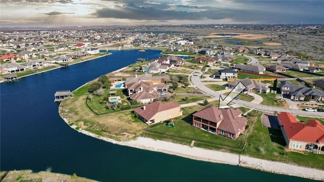 aerial view at dusk with a water view