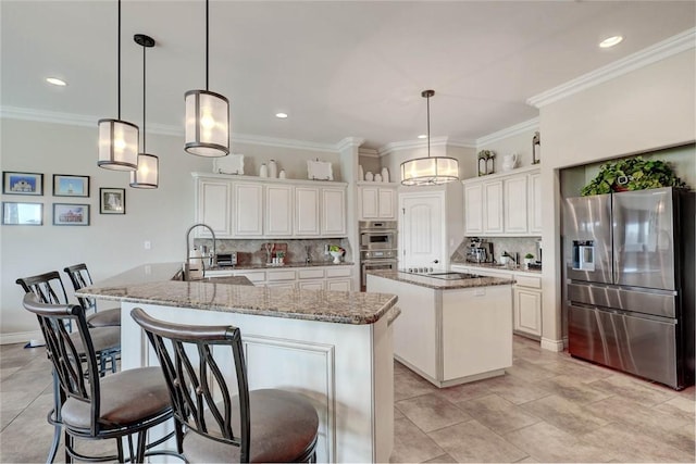 kitchen featuring pendant lighting, tasteful backsplash, stainless steel appliances, and an island with sink