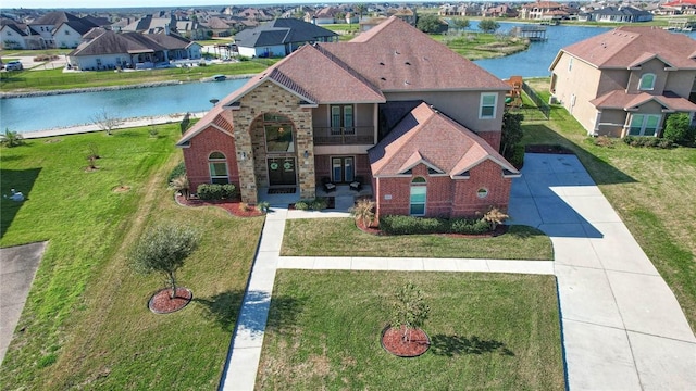 view of front of house with a balcony and a water view