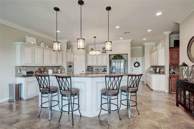 kitchen with pendant lighting, crown molding, a spacious island, and stainless steel appliances