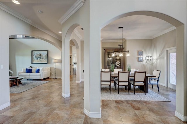 dining area with arched walkways, ornamental molding, recessed lighting, and baseboards