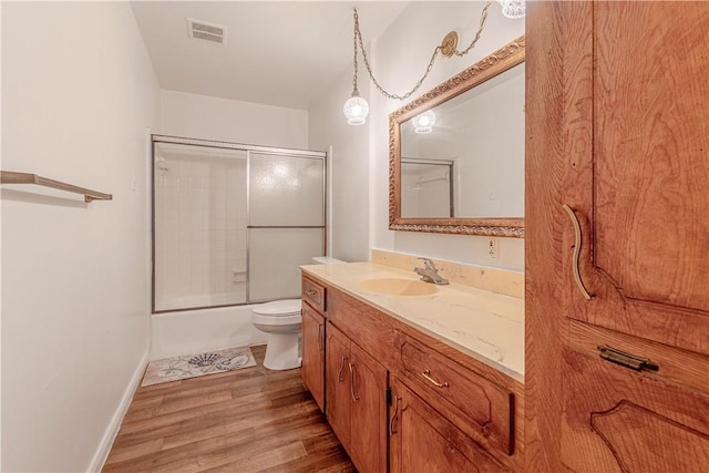 2406 Lakeview Dr, Rockport, TX 78382 - bathroom with vanity, bath / shower combo with glass door, and wood finished floors
