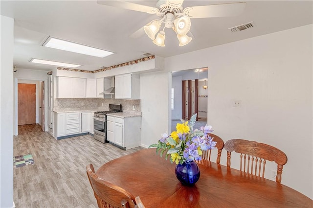2406 Lakeview Dr, Rockport, TX 78382 - dining room with a ceiling fan and light wood-type flooring