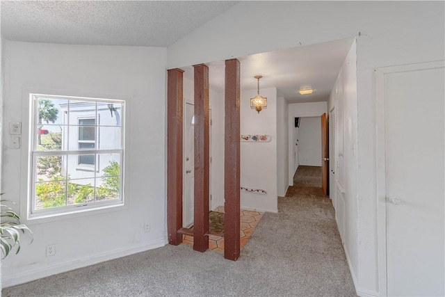 2406 Lakeview Dr, Rockport, TX 78382 - corridor with plenty of natural light, light carpet, and a textured ceiling