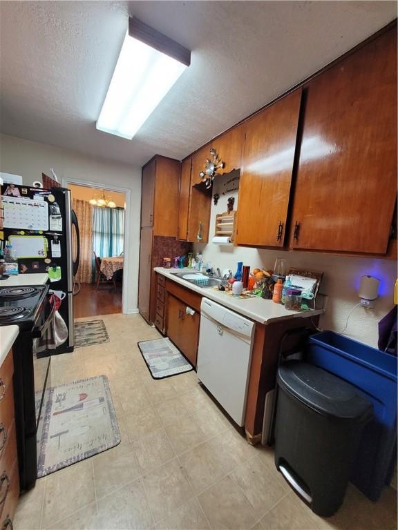 kitchen with sink, a textured ceiling, dishwasher, and black / electric stove