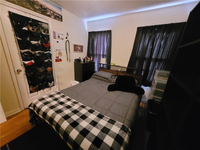 bedroom with wood-type flooring